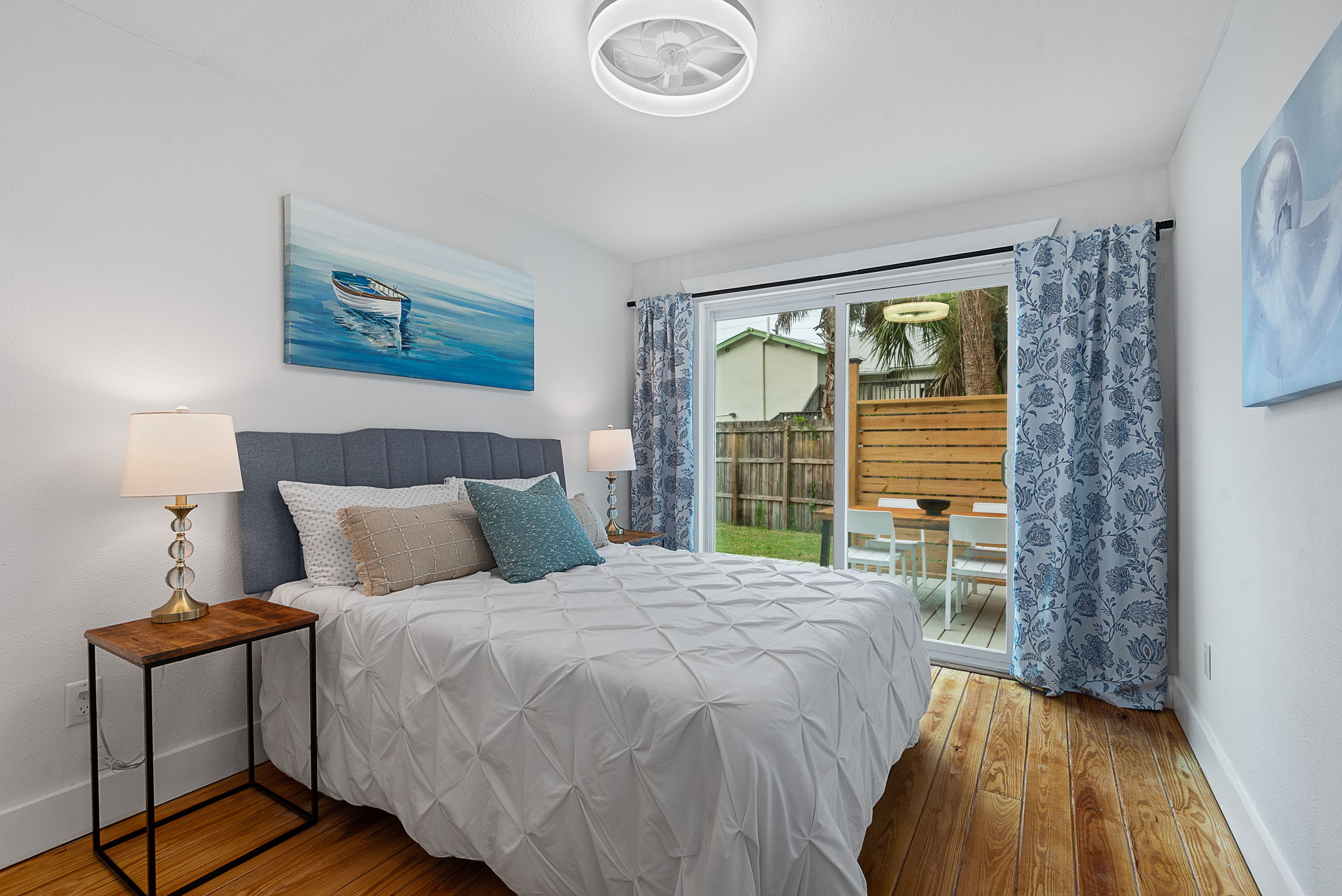 Primary bedroom with sliding glass doors to the back deck
